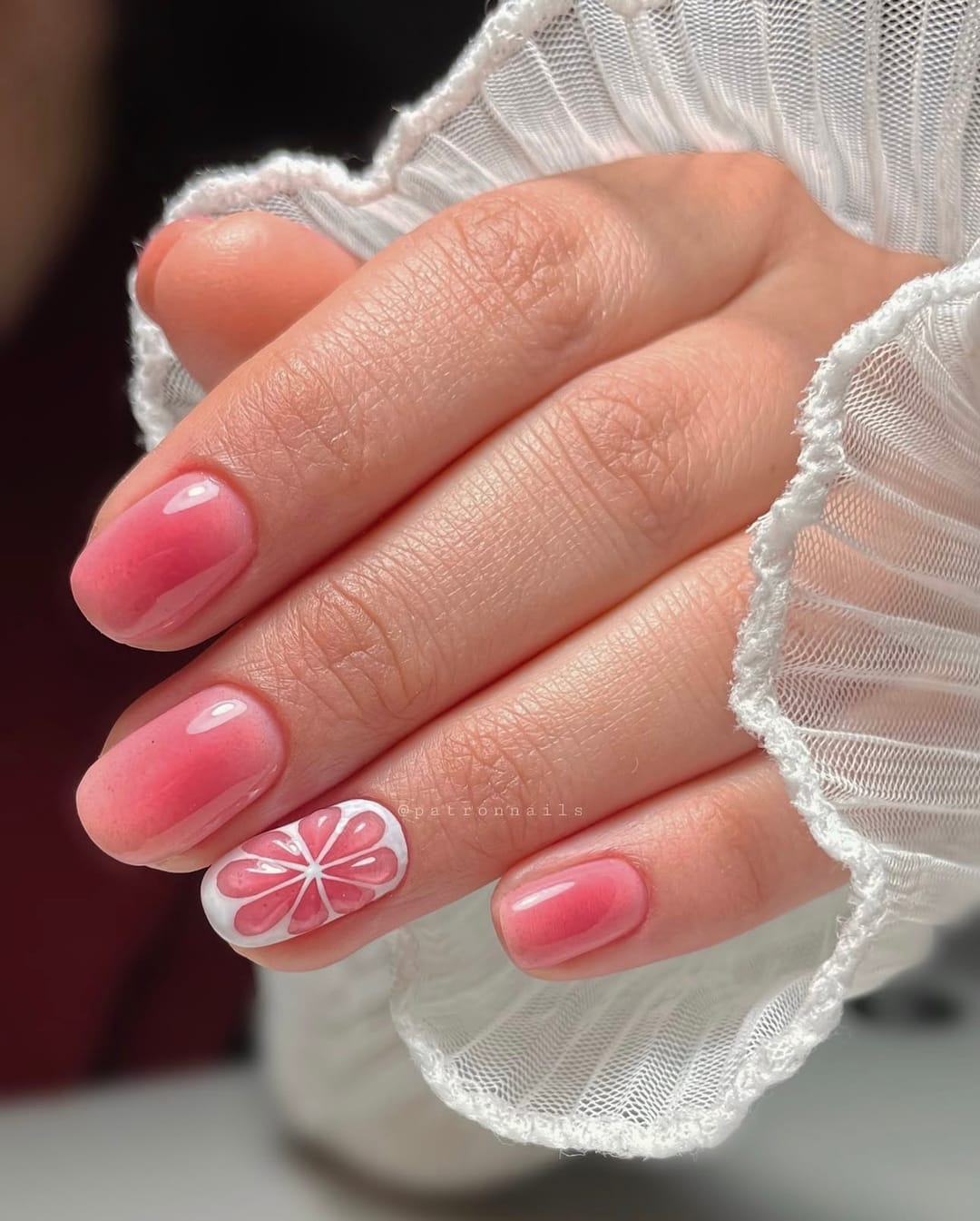 Pink blush ombré nails with a floral accent